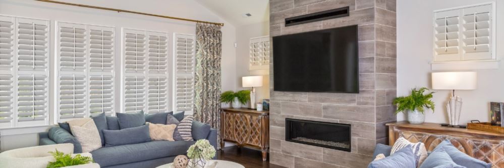 Plantation shutters in a Newport Beach family room with fireplace