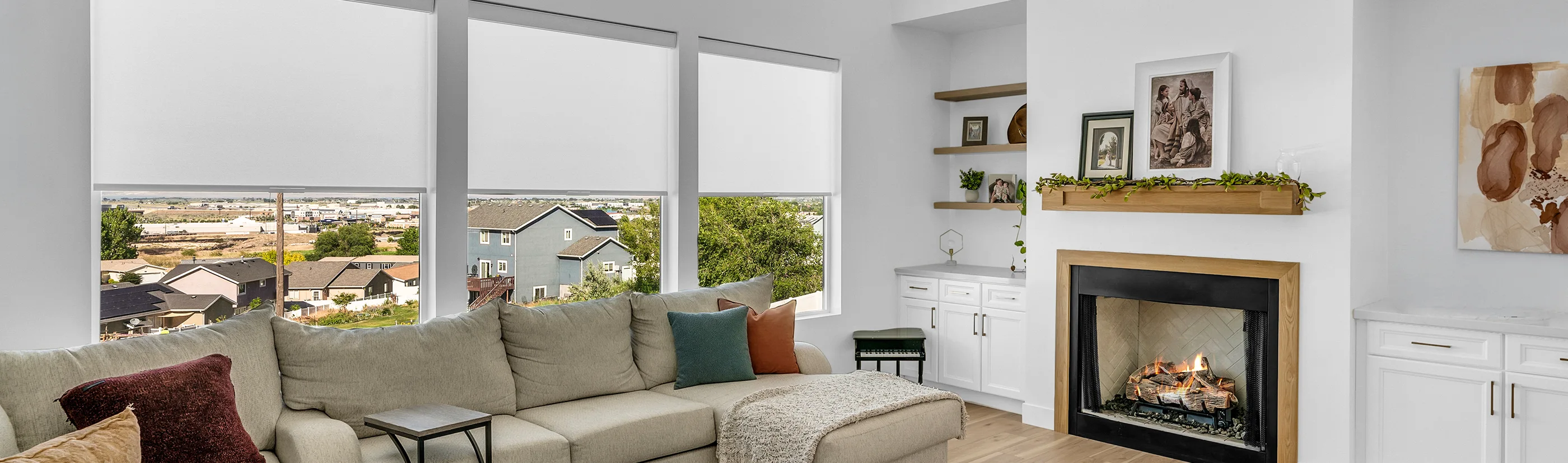 white motorized roller shades in a large living room 
