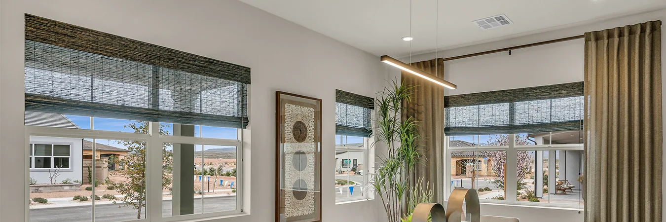 Brown woven shades pulled halfway down over dining room windows