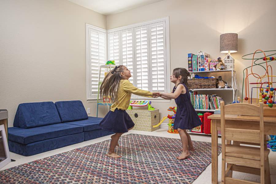 Choose Polywood shutters for durable, kid-friendly great room window treatments in Southern California. Polywood shutters on multiple windows in a sitting area