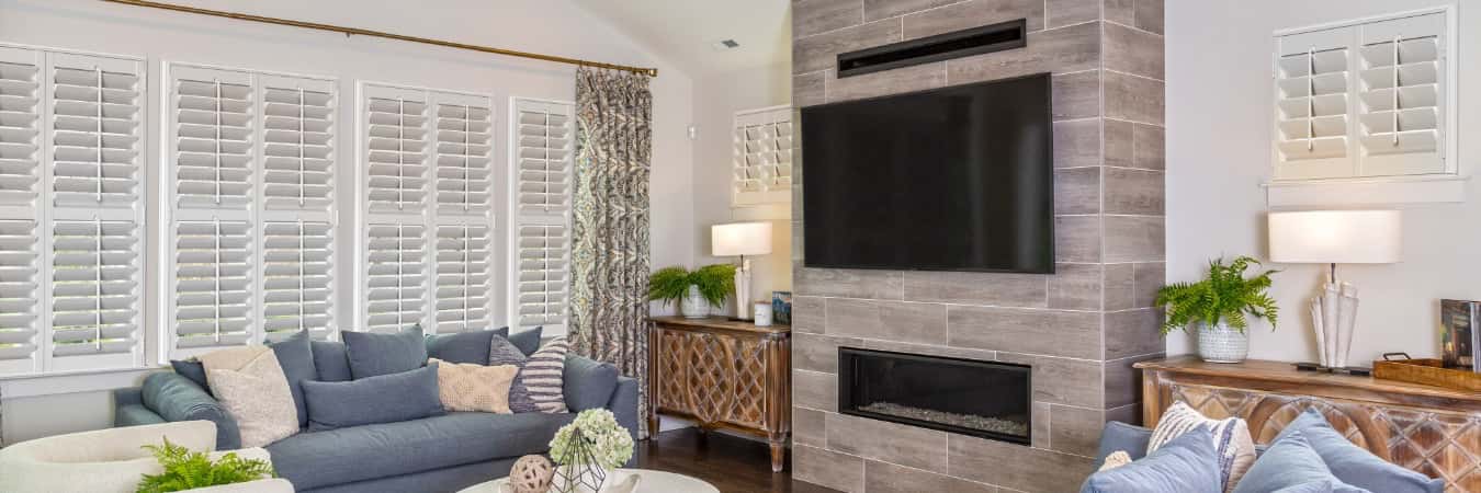 Plantation shutters in Orange County family room with fireplace