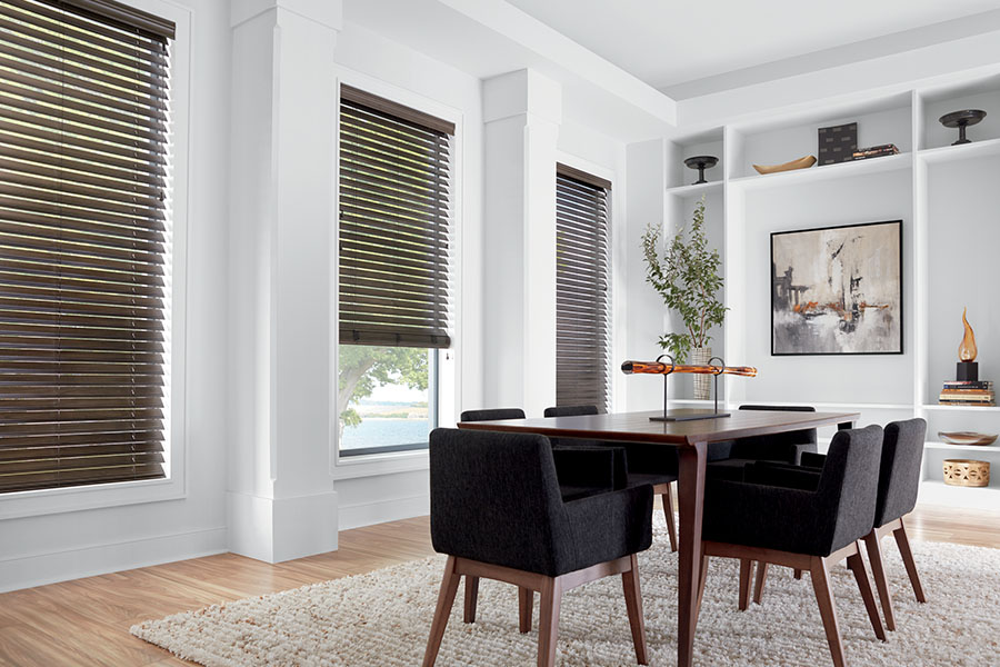 Dark brown blinds on windows in a dining room