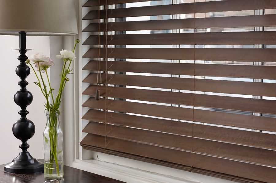 Custom-made blinds fit your windows perfectly. Close-up view of inside-mount wood blinds