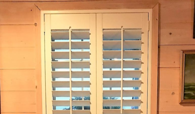 Plantation shutters fit many window shapes and sizes. Plantation shutters in a long window.