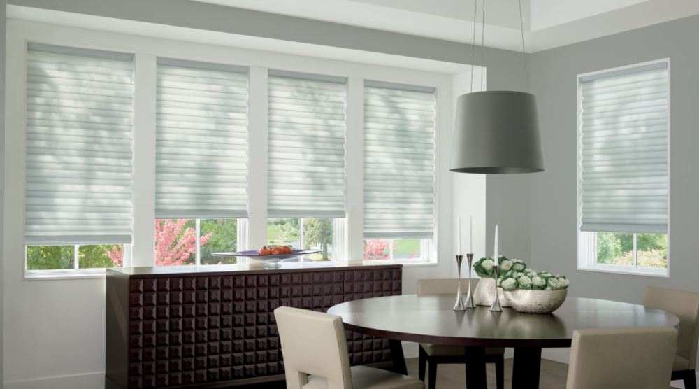 Custom cordless roller shades have a clean look and are appropriate for any room. Cordless motorized shades in a Southern California dining room