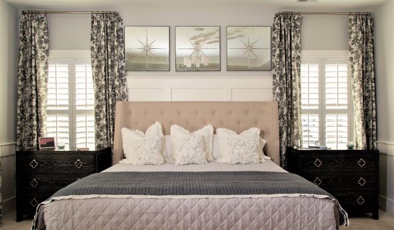 Plantation shutters will never change colors or crack. Plantation shutters in a bedroom.