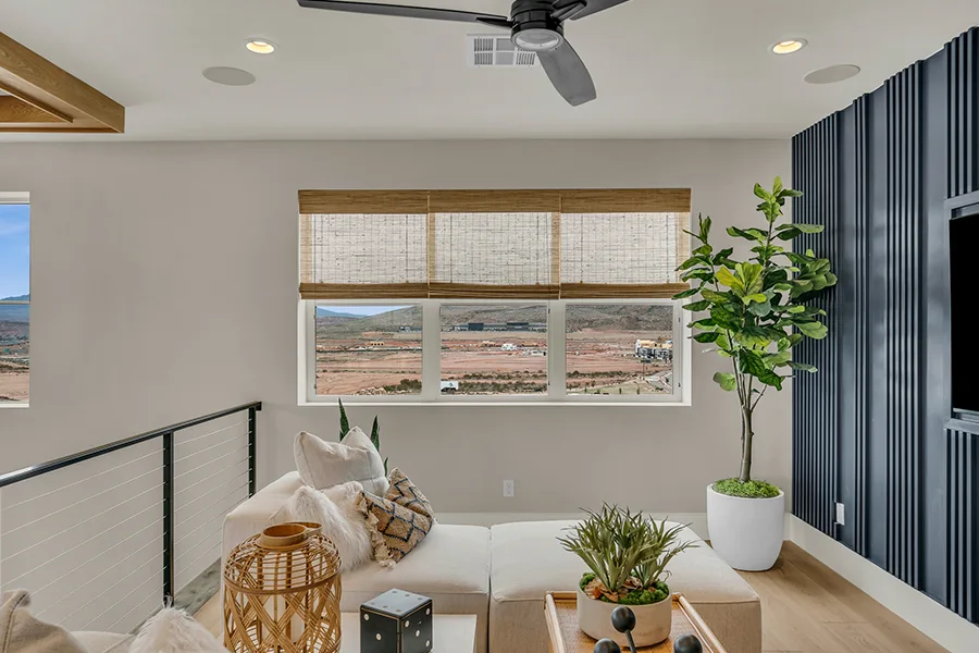 Southern California homeowners who want eco-friendly home fixtures should consider natural woven shades. Natural brown woven shades on a window in a stylish sitting area
