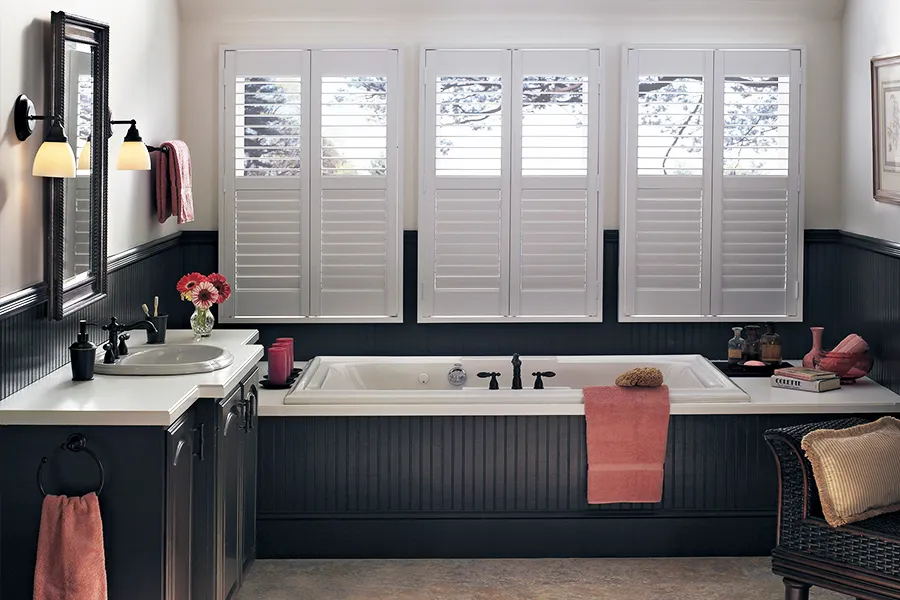 Plantation shutters look best when an expert measures your window and installs them. White Polywood shutters on a bathroom window