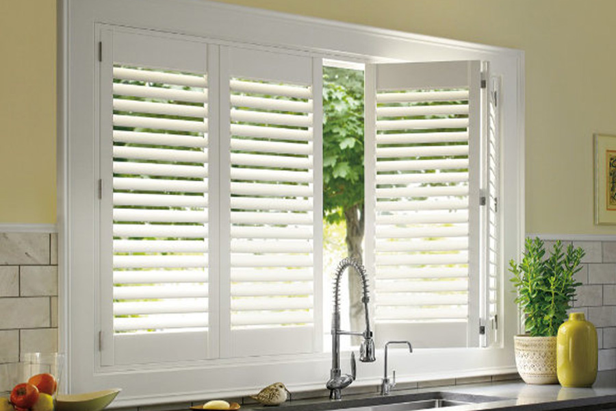 Polywood shutters are built to withstand the test of time in Southern California. White Polywood shutters above a kitchen sink.